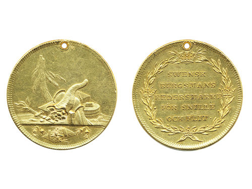 Medals, regal, Sweden. Adolf Fredrik, Hild. 58, Adolf Fredrik, gold medal in 8 ducat weight (pierced, presumably at issue), 35 mm, 27.55 g. Award medal for Mining workers, engraved by Daniel Fehrman. Obv: Picture of tools, tree and other items related to mining and an inverted cornucopia with coal. Rev: Crowned wreath around SWENSK BERGSMANS HEDERSMÄRKE FÖR SNILLE OCH FLIT. Very scarce. Lightly cleaned, some rim filing. 1+/01.